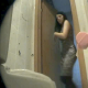 A woman with a shapely body pees and poops on a toilet, and the entire event is captured on video by a hidden camera mounted on the floor behind the toilet.